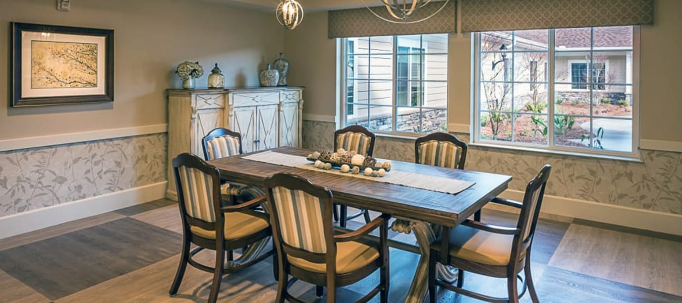 Bright dining room with a large table and windows