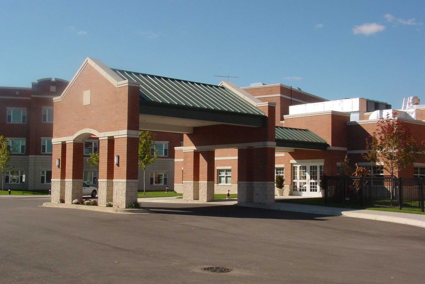 Entrance of a senior living facility with a covered entrance.