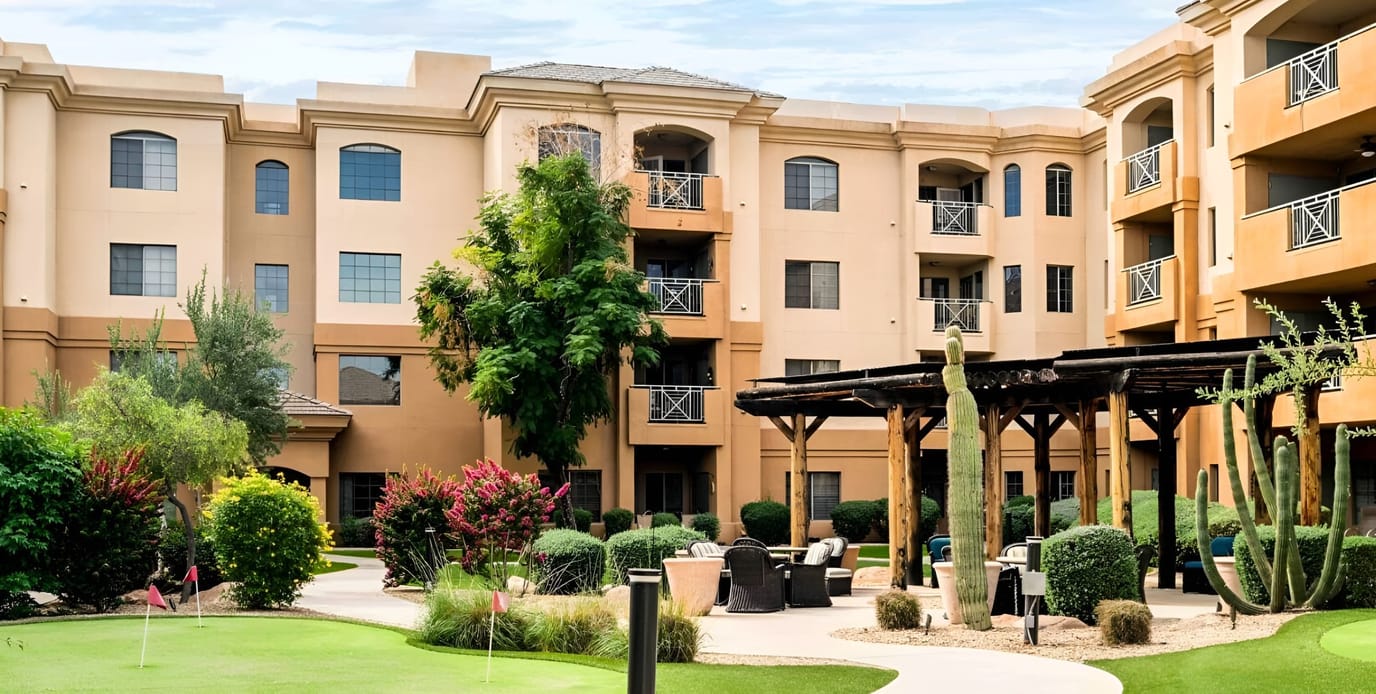 Exterior view of a senior living facility with gardens