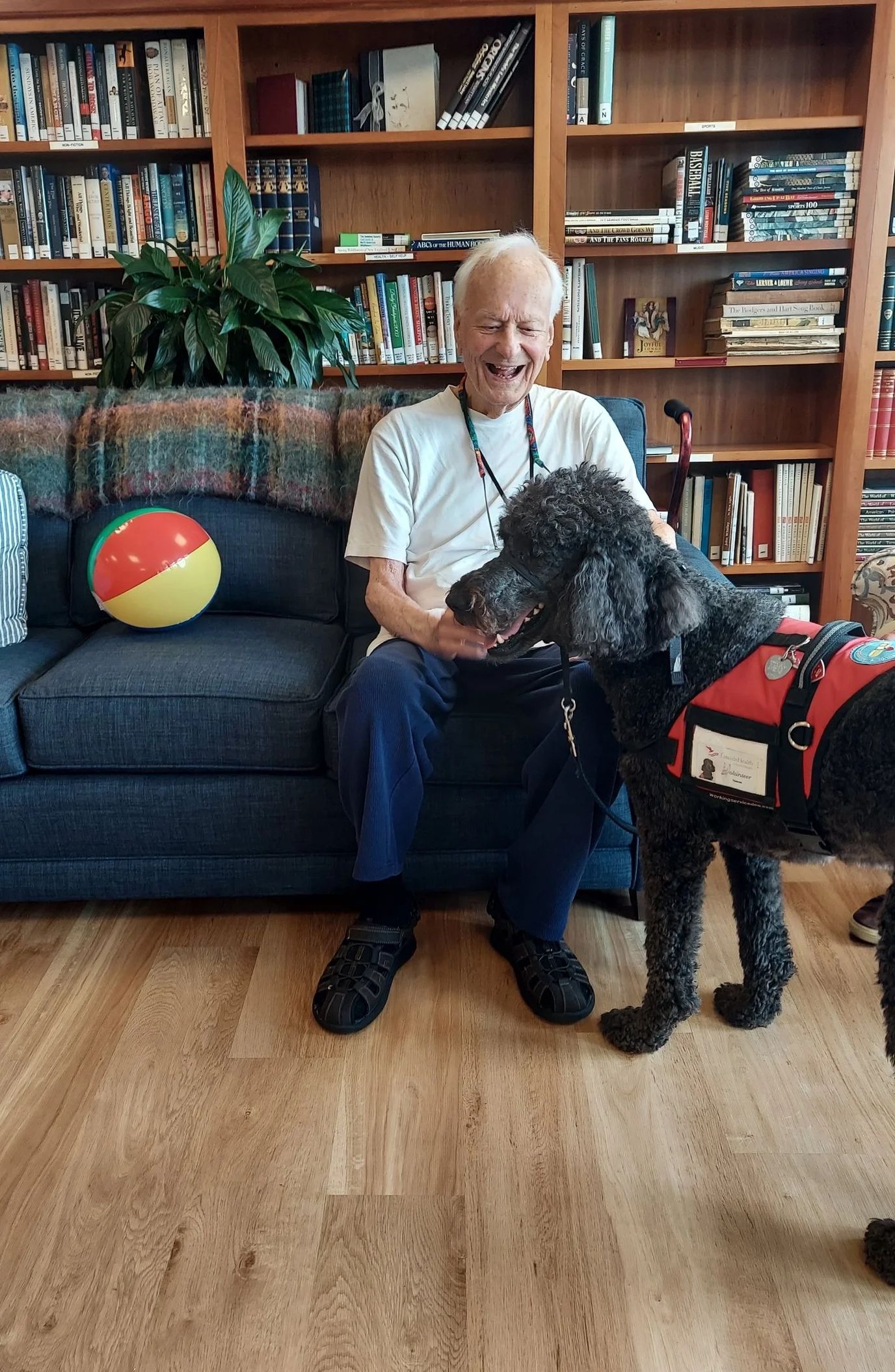 Resident interacting with a therapy dog indoors