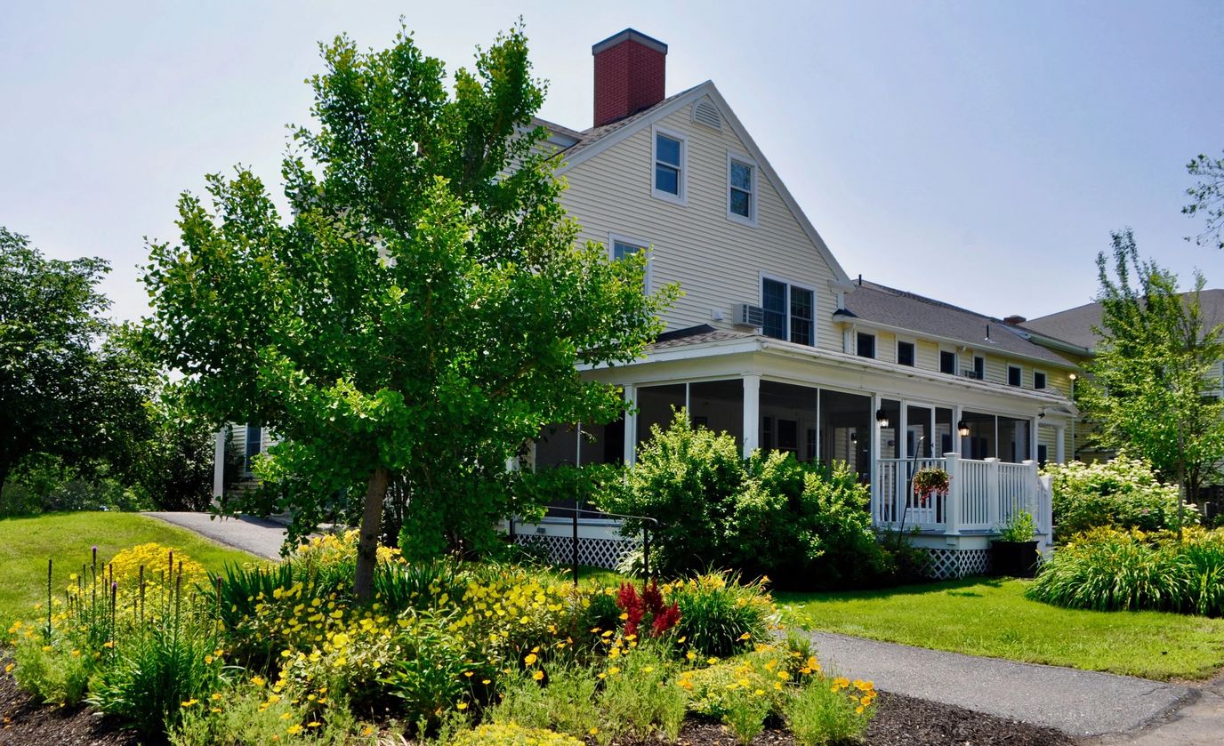Exterior view of The Lincoln Home with garden and porch.
