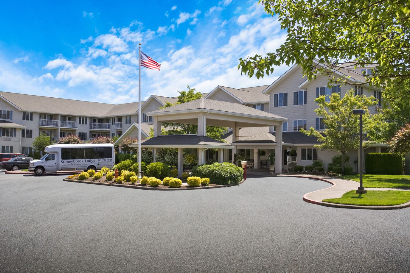 Entrance of Stoneybrook Lodge with landscaping and vehicle