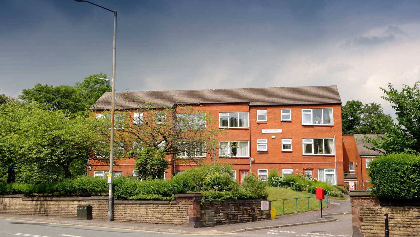 Exterior view of Anchor Court facility with greenery
