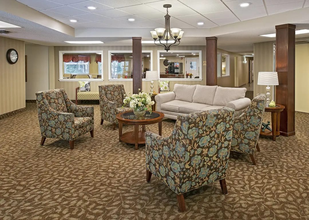 American House Westland Hunter, assisted living in Westland, MI — Cozy lounge area with floral-patterned chairs and sofa