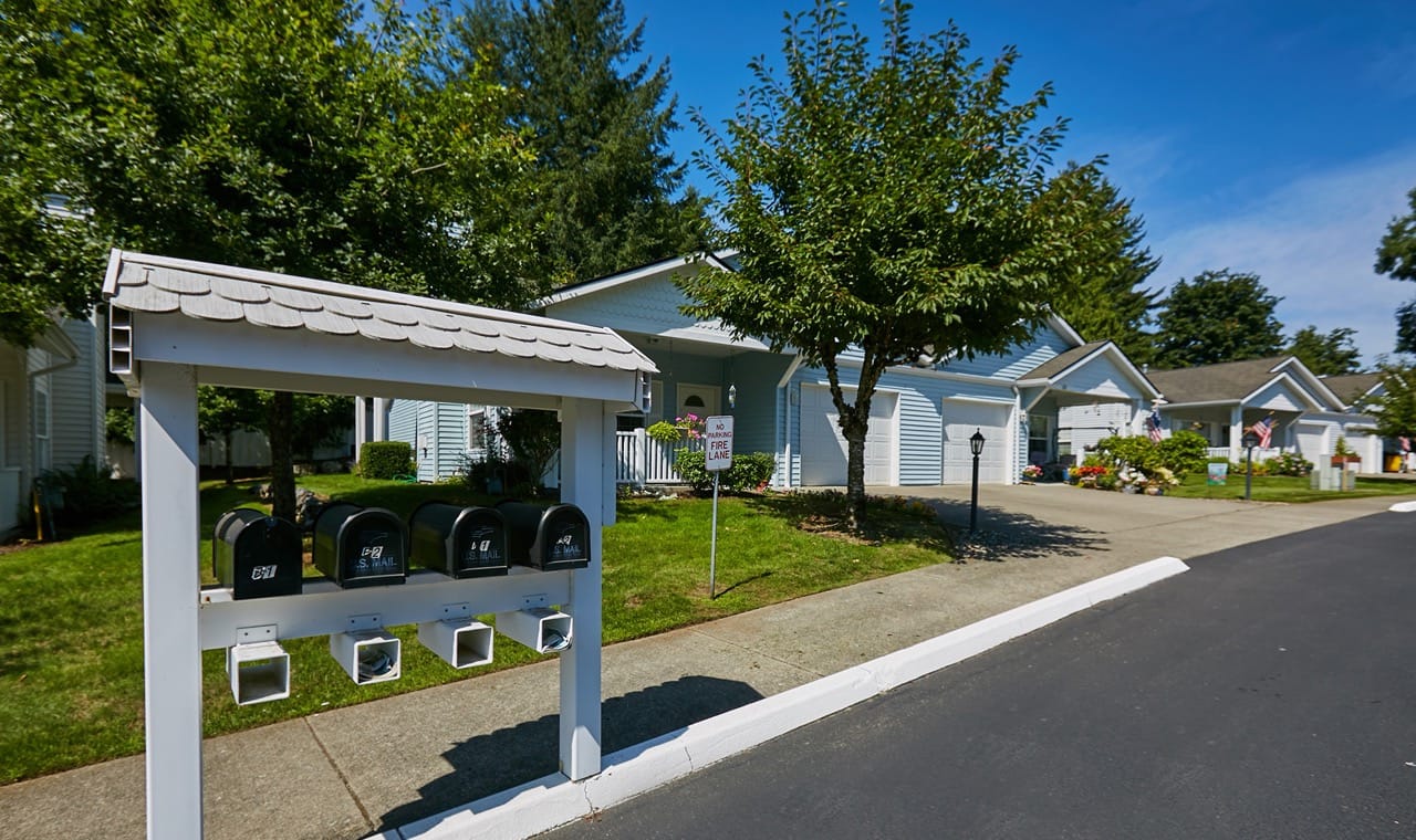 Exterior view of a senior living facility with mailboxes