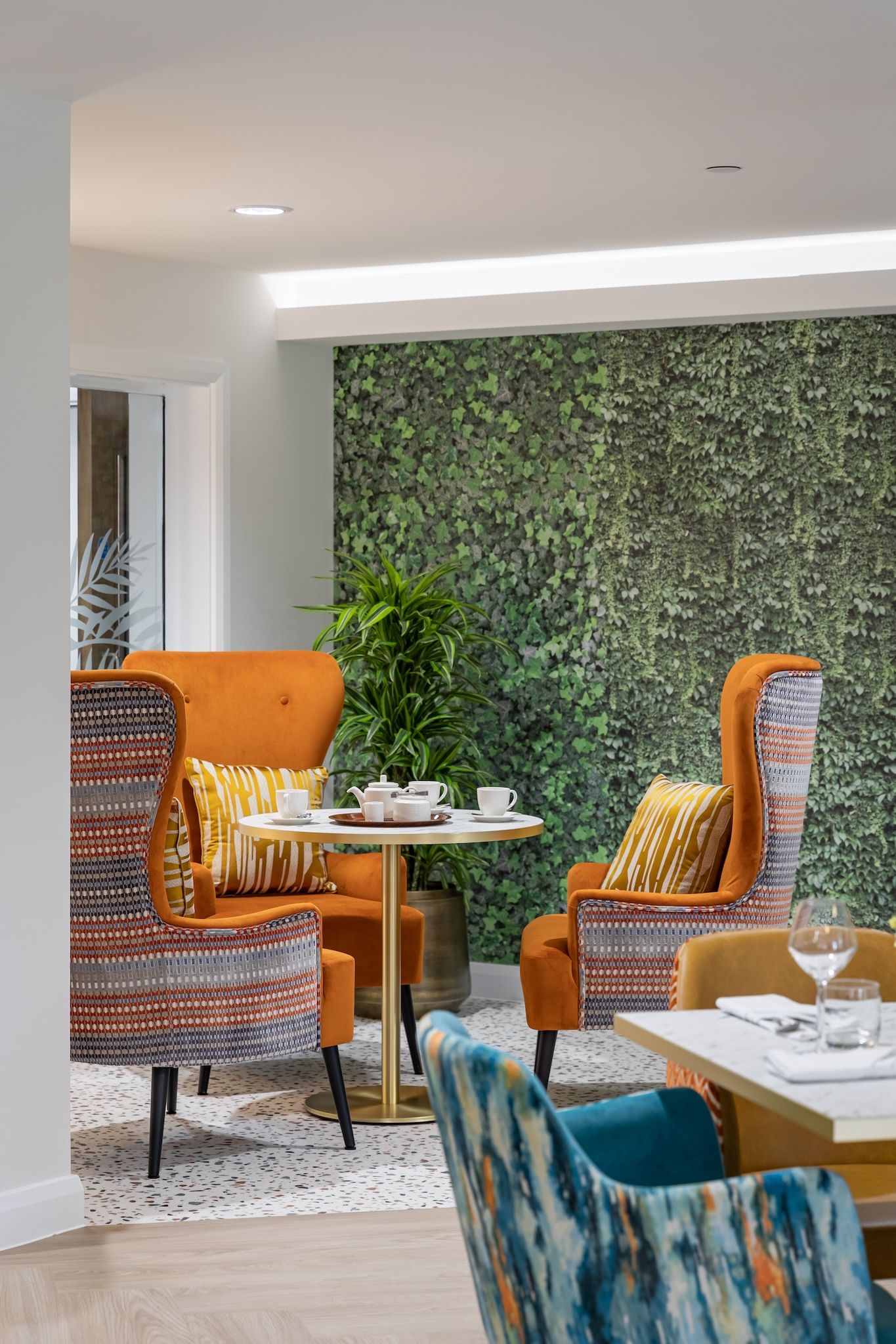 Cozy common area with orange chairs and green wall