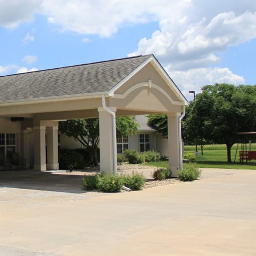 Vintage Park at Kansas, assisted living — Entrance of a senior living facility under a blue sky