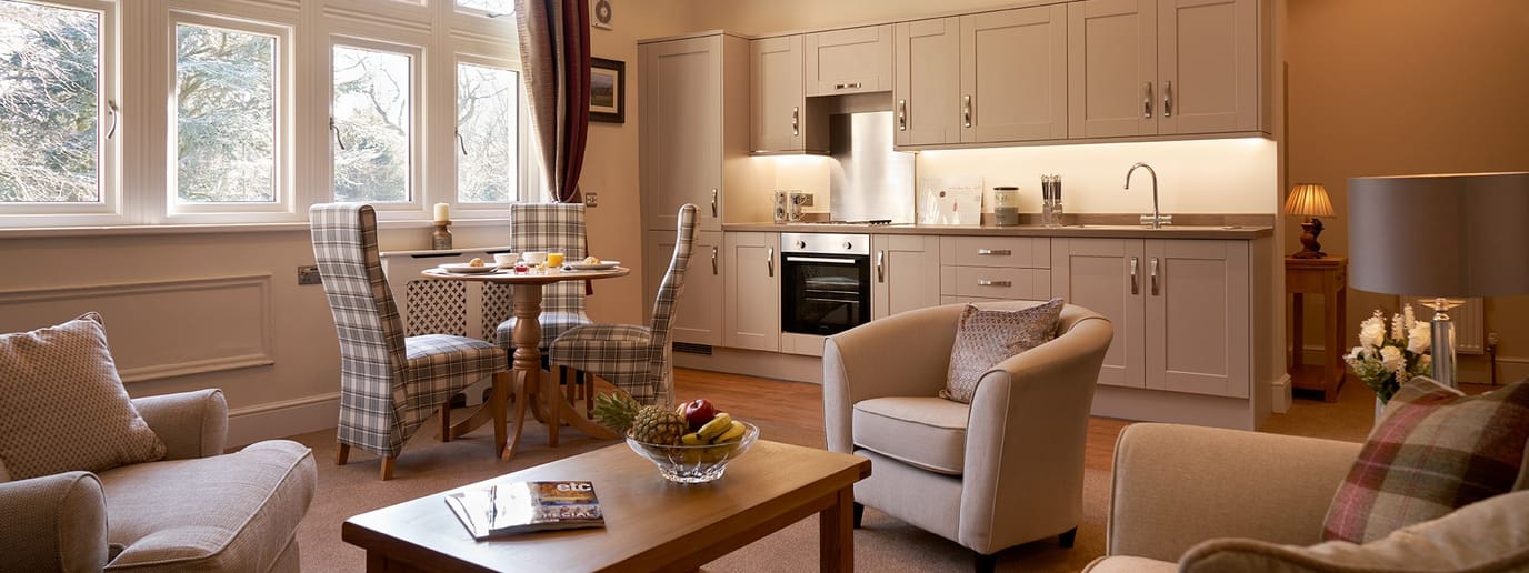 Southlands Retirement Apartments, retirement village in Leeds, UK — Modern kitchen with dining area in a cozy apartment