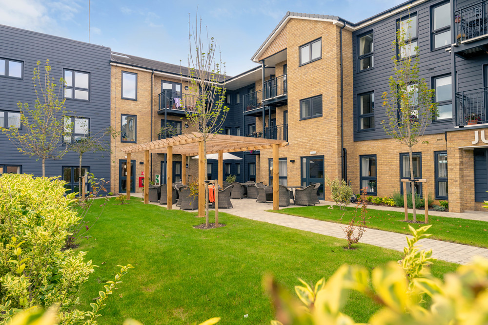 Outdoor seating area with landscaped garden.