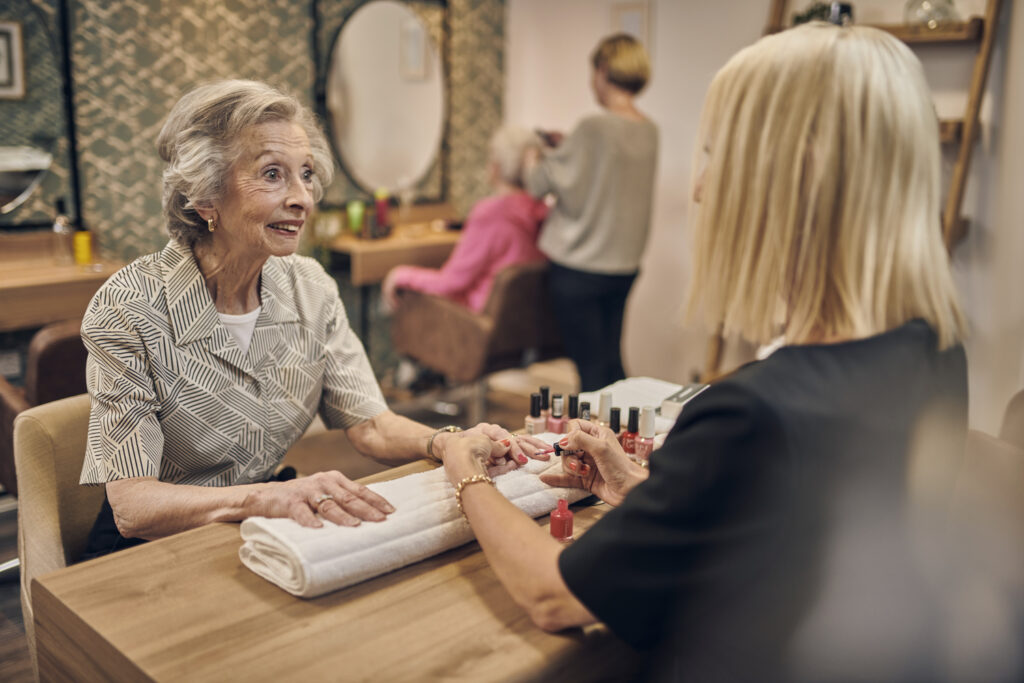 Senior woman enjoying a manicure at a salon