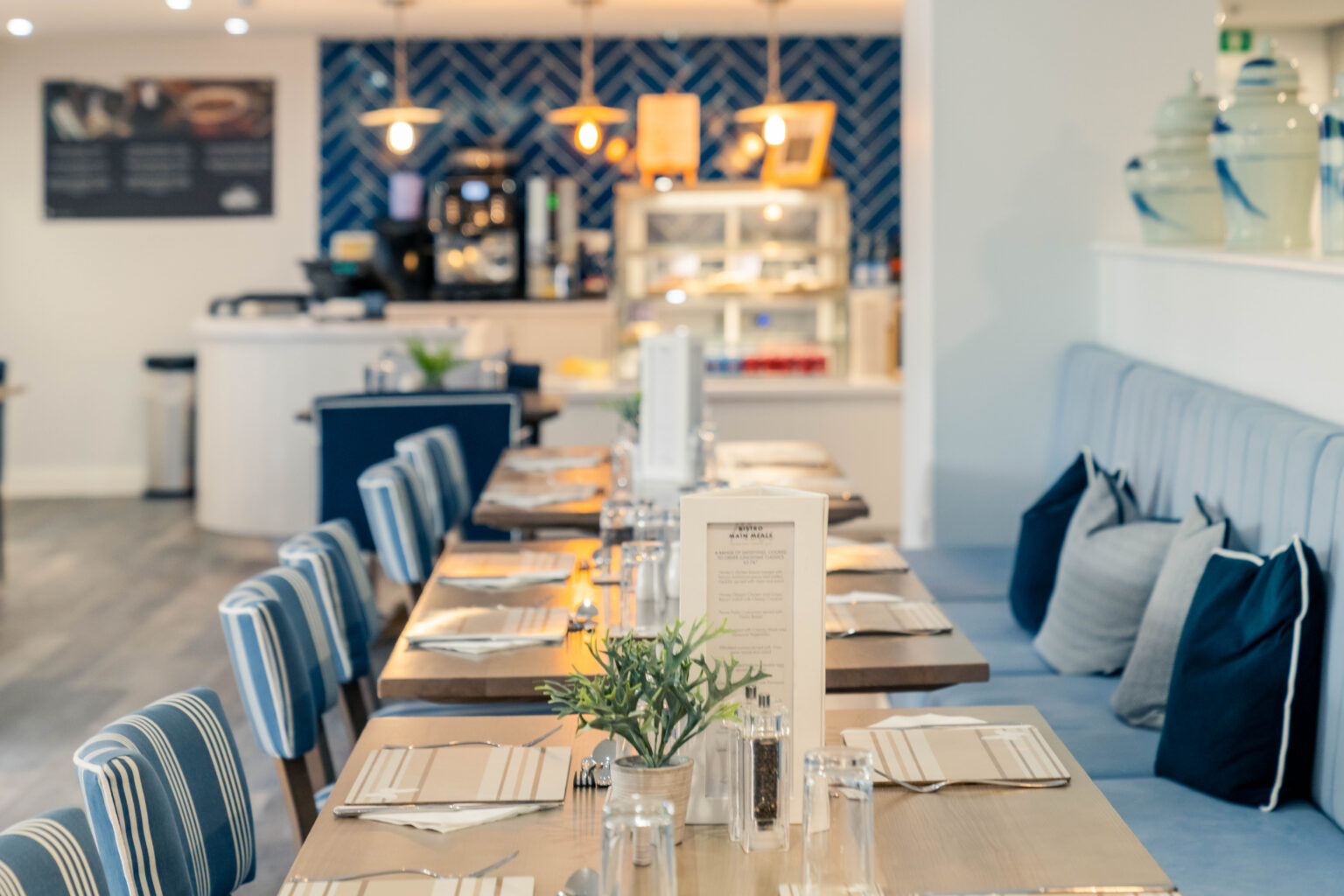 Dining area set up for a meal with tables and chairs.