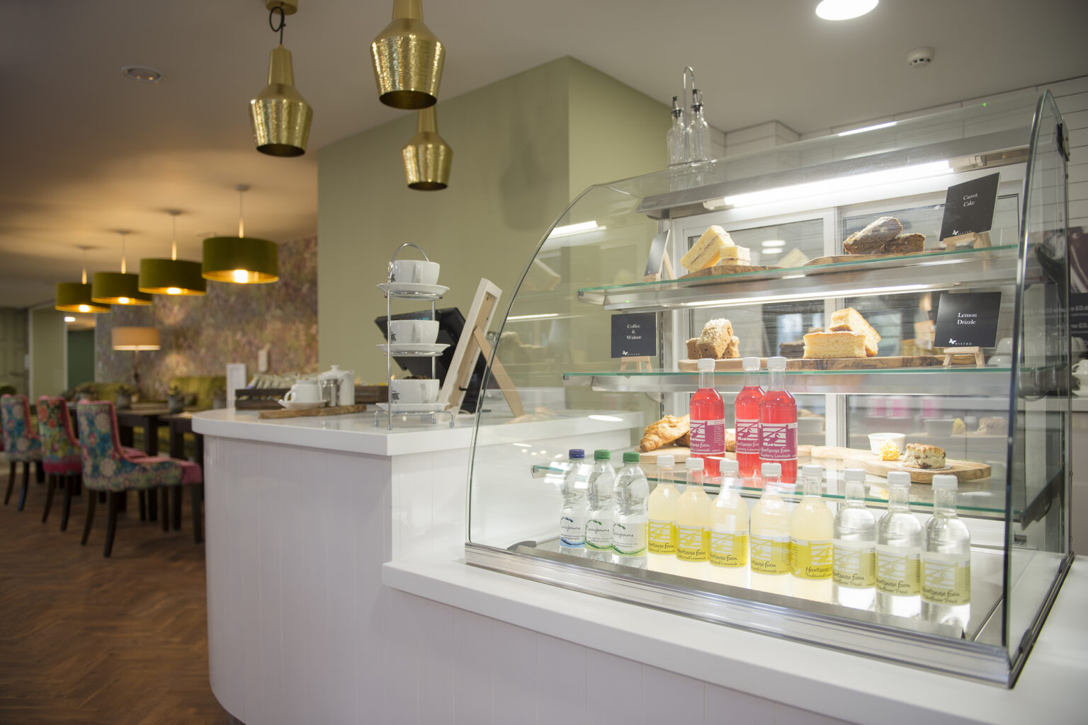 Food display in a dining area with refreshments and pastries.