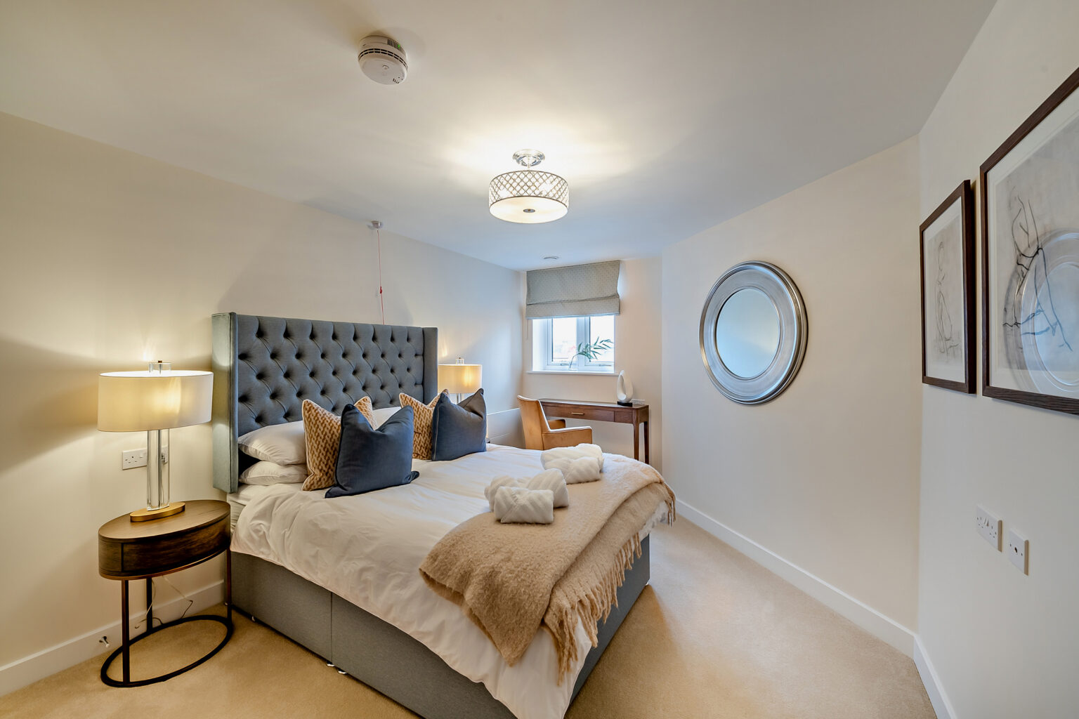 Cozy bedroom with elegant decor and lighting.