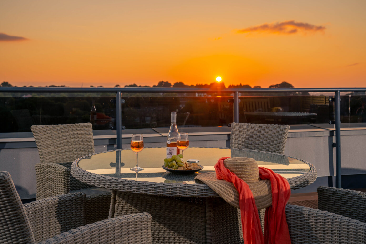 Outdoor dining setup with sunset view.