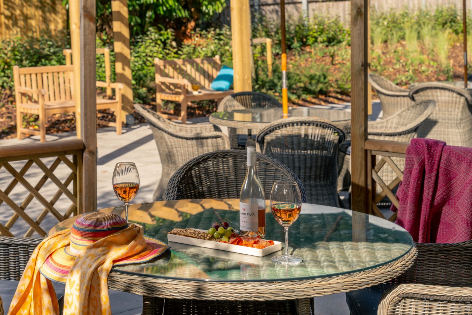 Outdoor dining area with wine and snacks