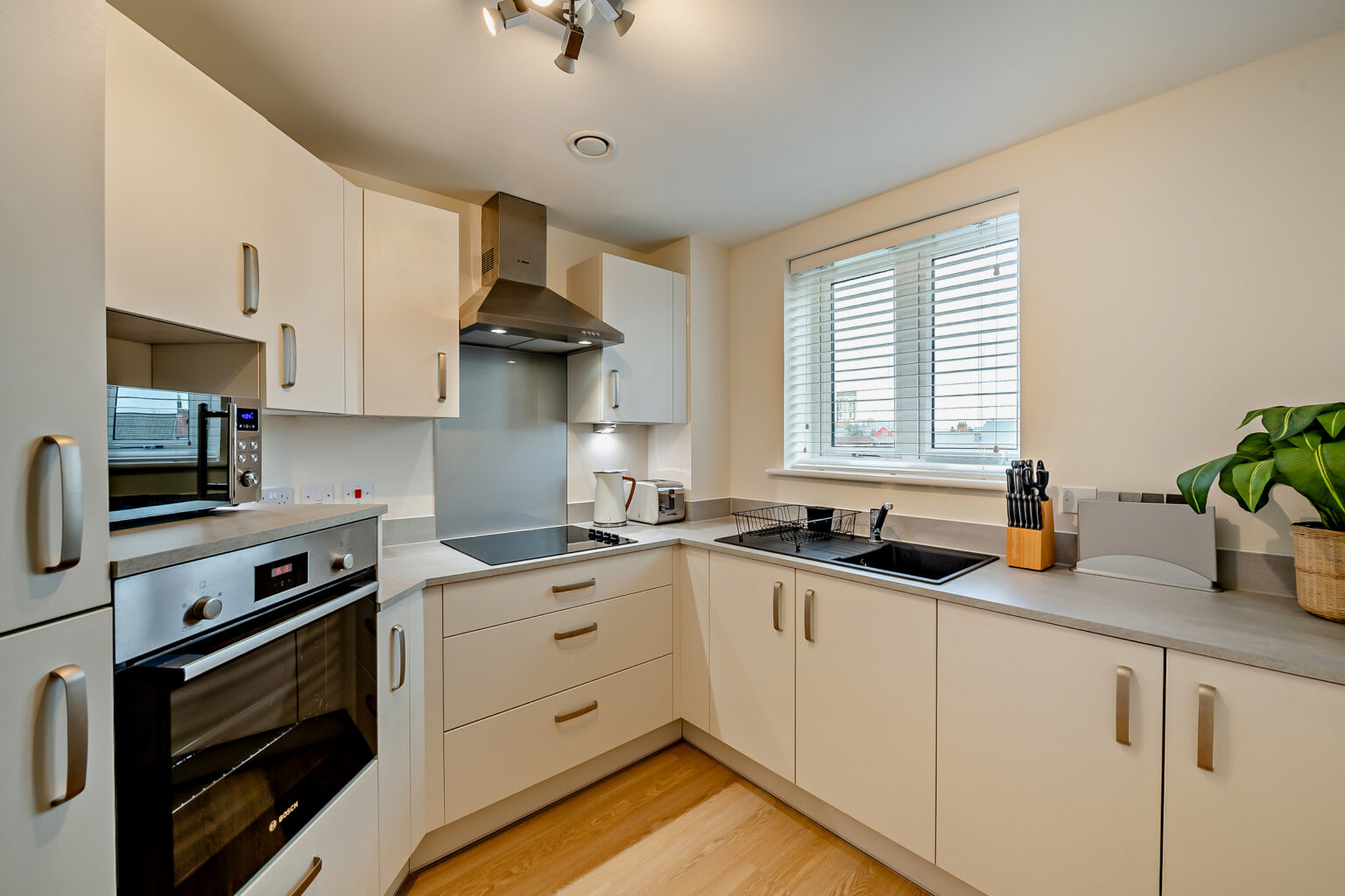 Modern kitchen interior with appliances and window.