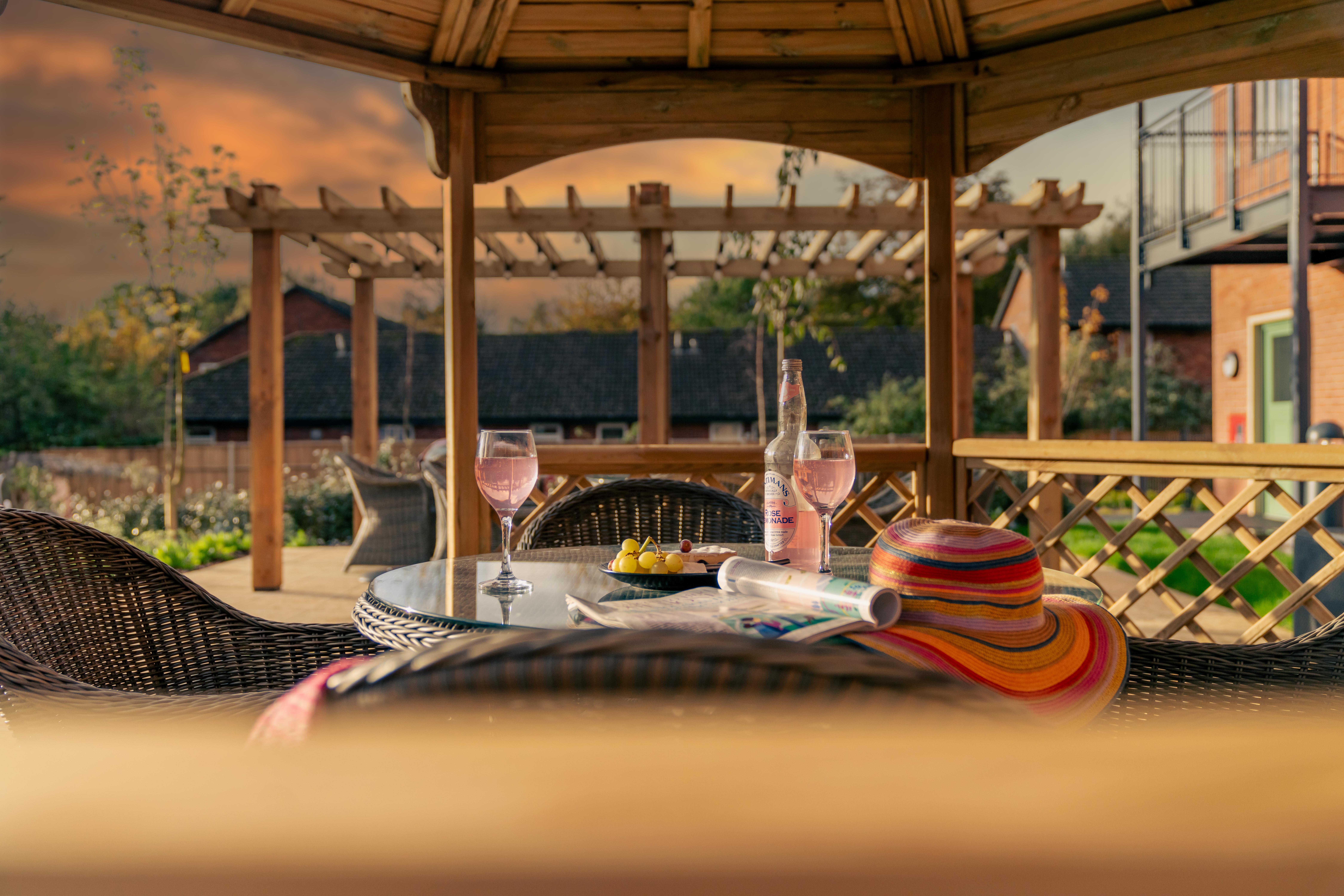 Gazebo with drinks and a hat during sunset