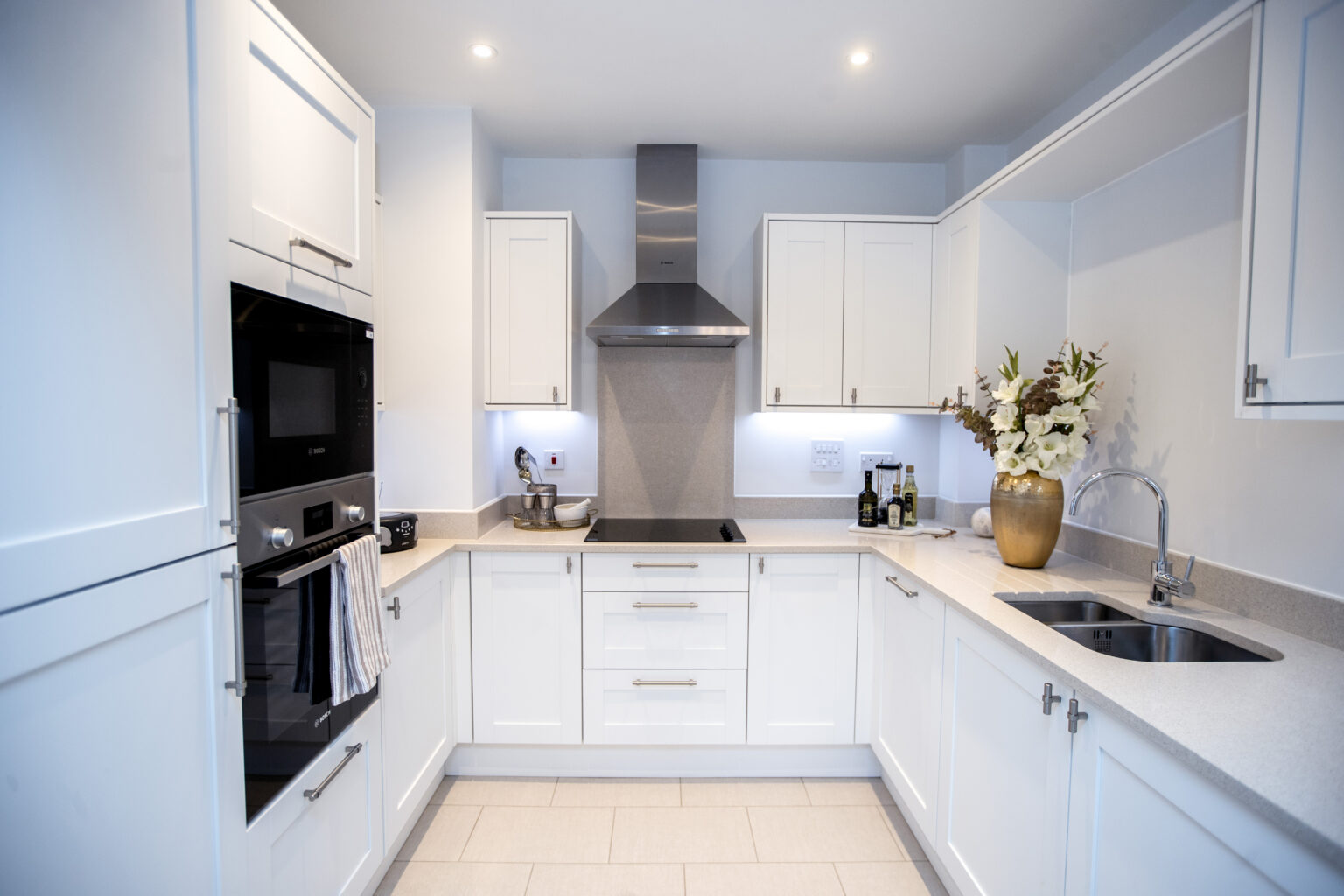 Modern kitchen with white cabinetry and decor