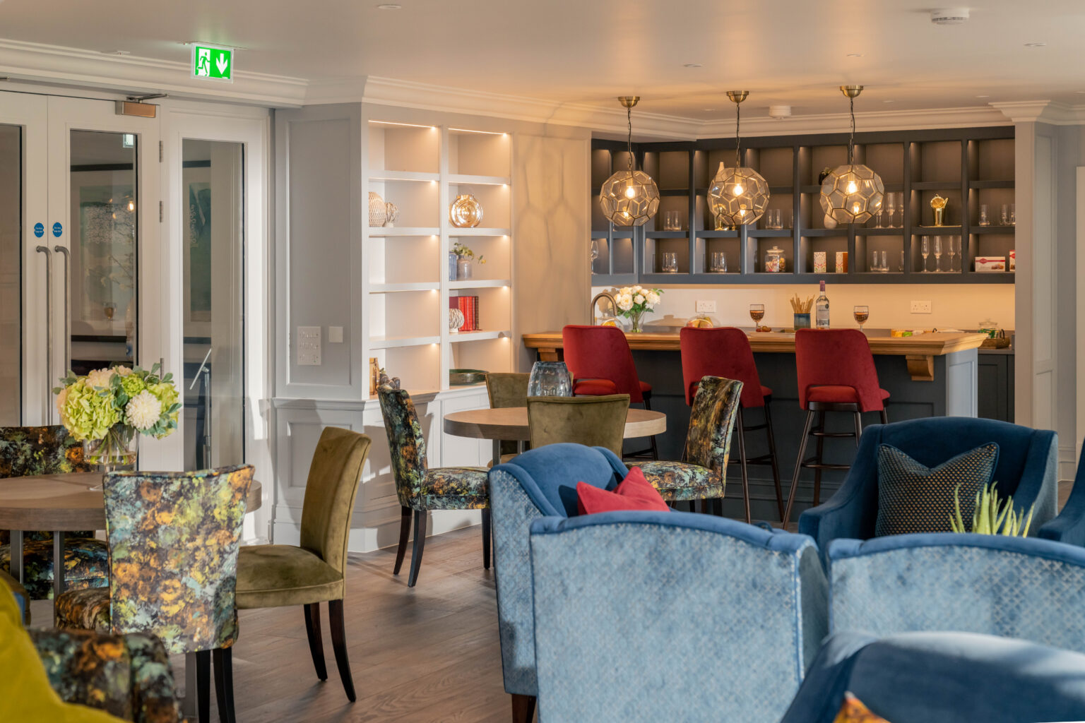Interior lounge area with colorful chairs and bar