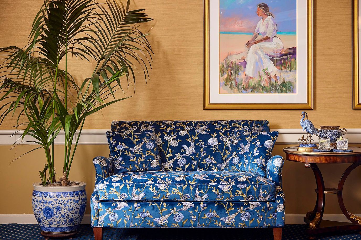 Cozy interior with a floral patterned sofa and artwork