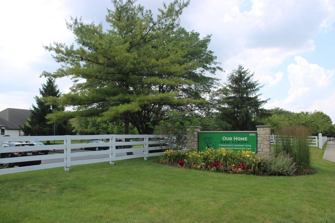 Outdoor view of Our Home nursing home sign and landscape