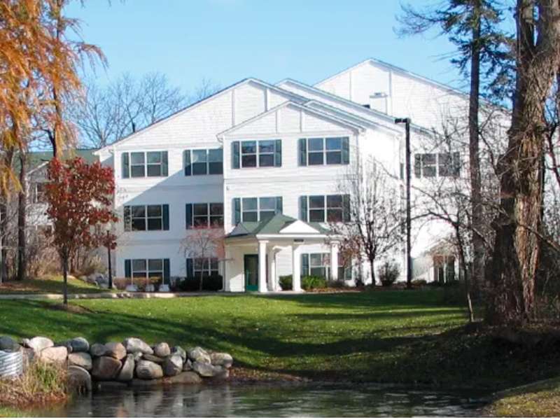 Exterior view of a senior living facility with greenery