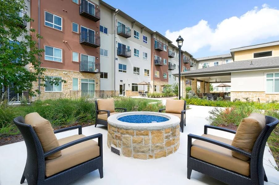 Outdoor seating area with chairs and fire pit