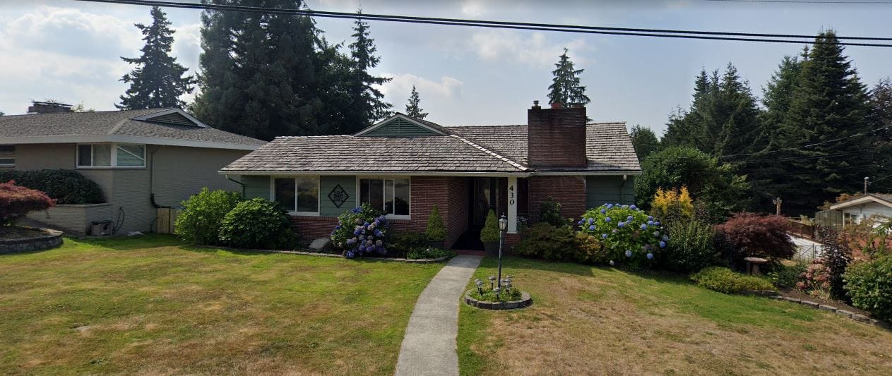 Exterior view of Amy's Adult Care Home with garden and lawn