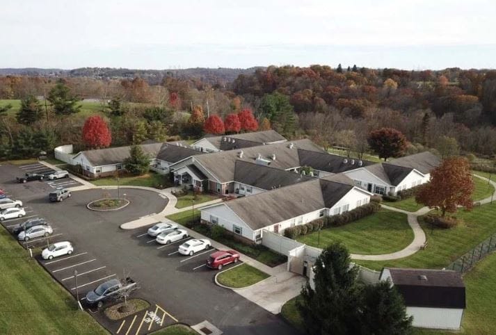 Aerial view of the Arden Courts facility with fall foliage