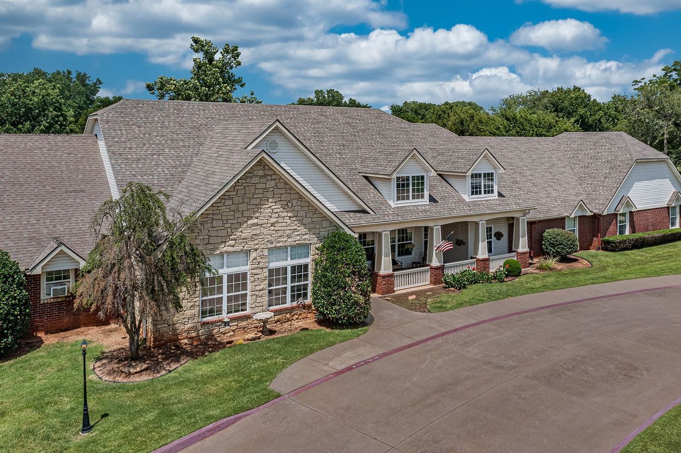 Exterior view of Ashbrook Village facility showing gardens and entrance