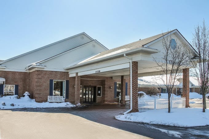 Entrance of a senior living facility covered in snow