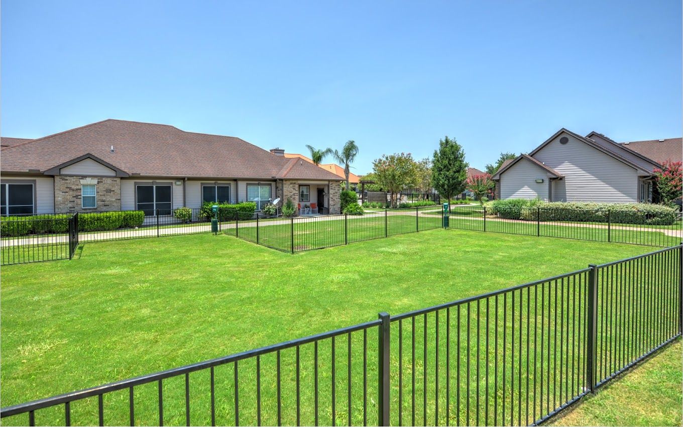 Outdoor space with well-maintained grass and fencing
