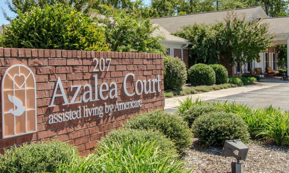 Exterior view of Azalea Court Senior Living entrance and sign