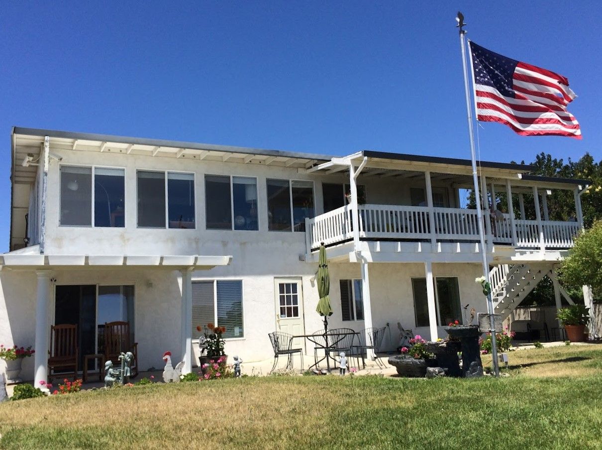Exterior view of a senior living facility with outdoor seating