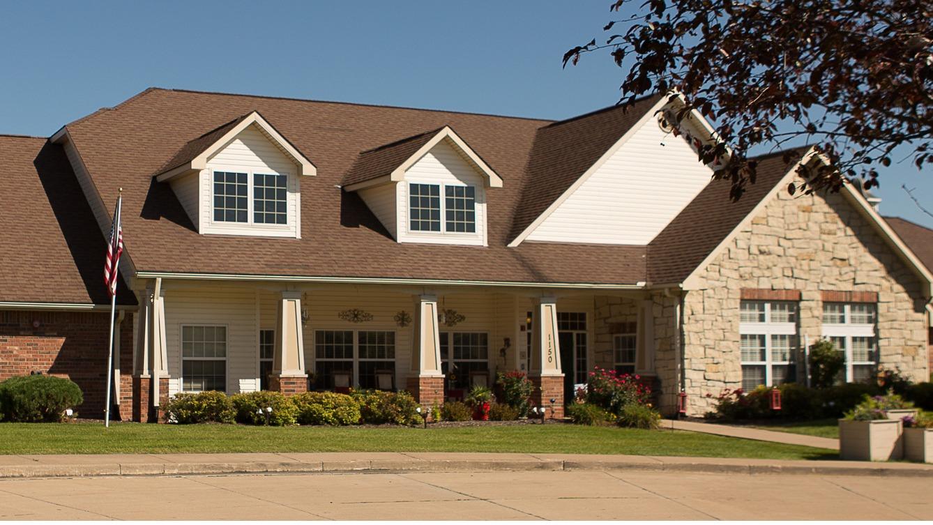 Exterior view of a senior living facility with a garden