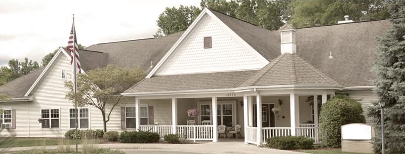 Exterior view of a senior living facility with greenery