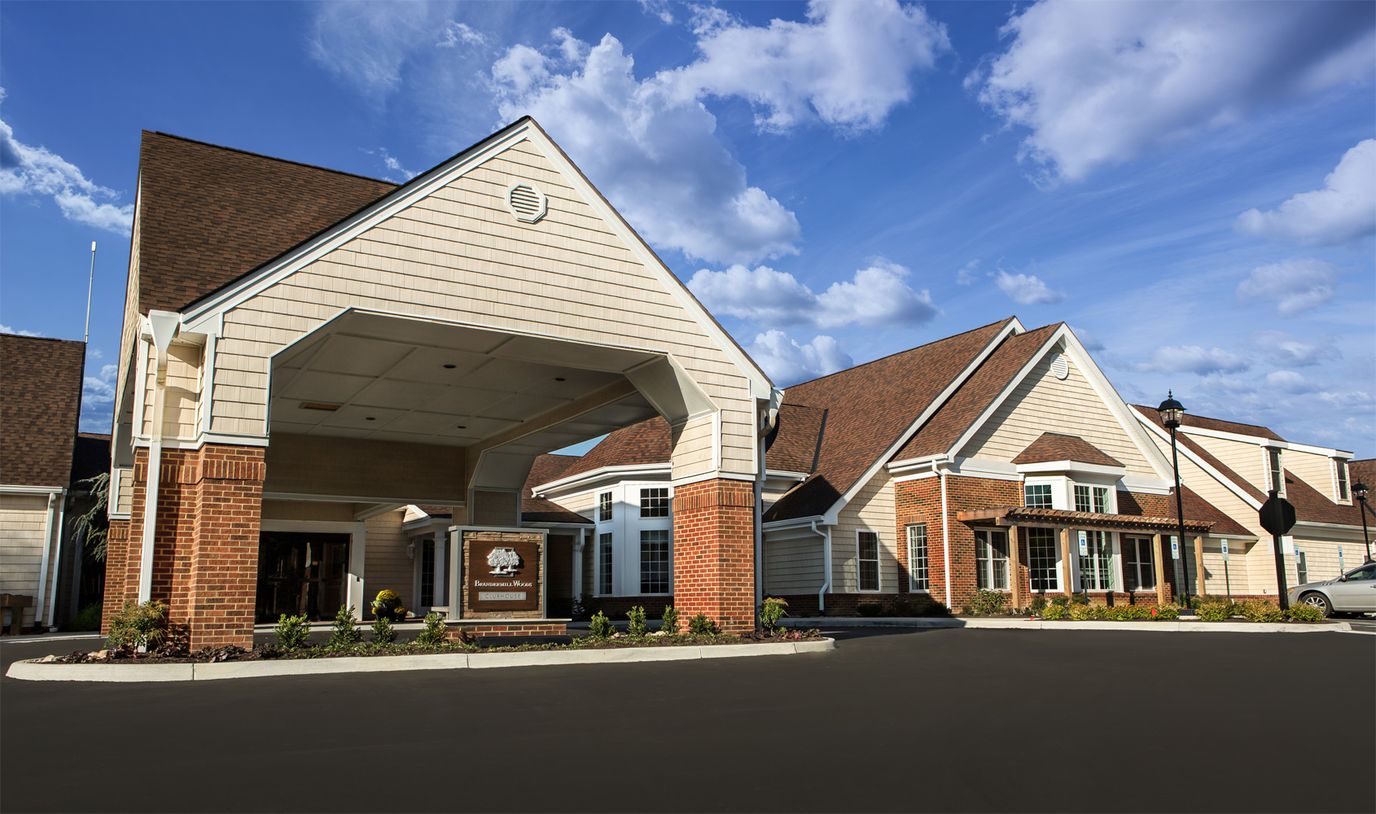 Exterior view of a senior living facility with covered entrance