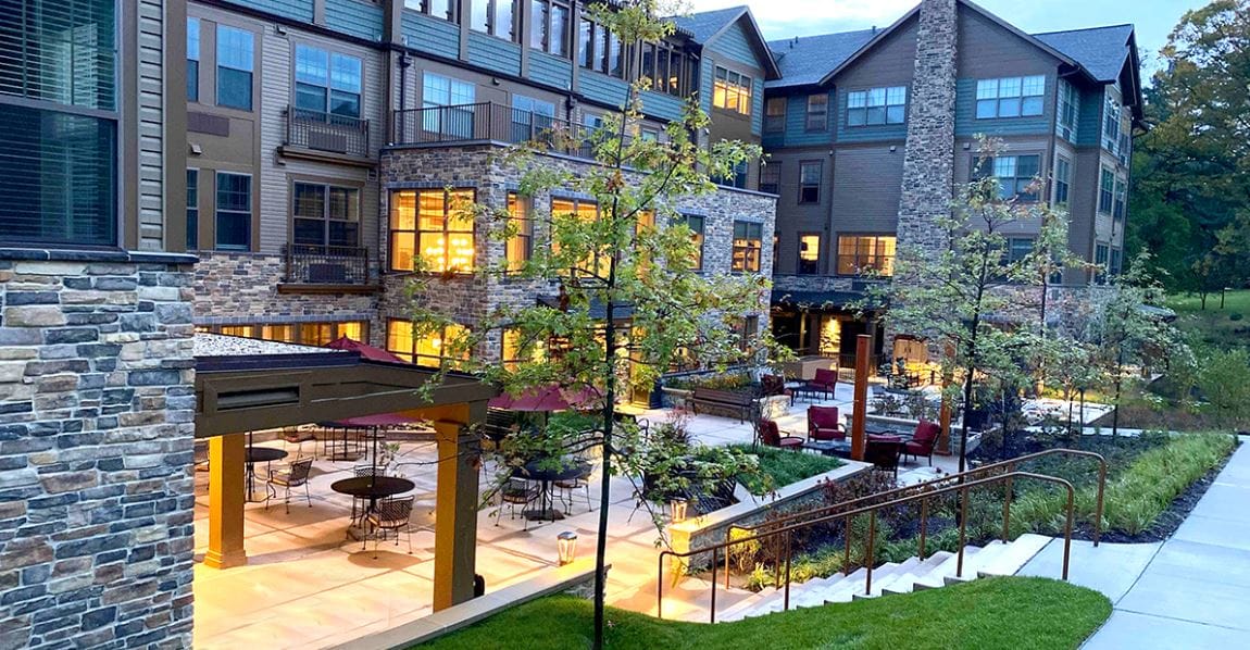 Building exterior with outdoor seating area at twilight