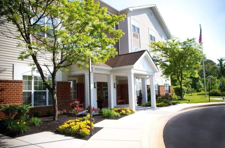 Exterior view of a nursing home entrance with landscaping