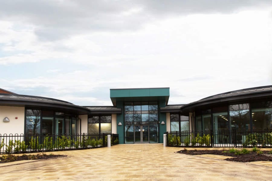 Exterior view of Cecil Gardens with landscaped entrance