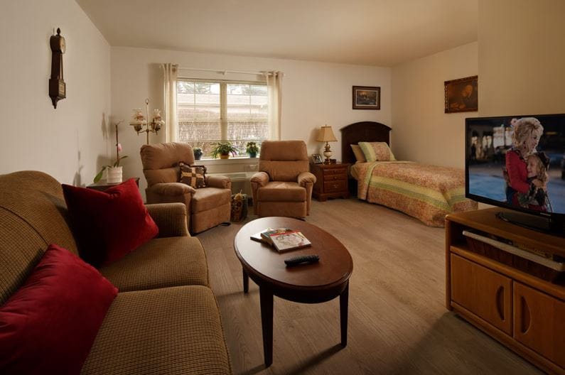 Comfortable living room area with seating and a bed