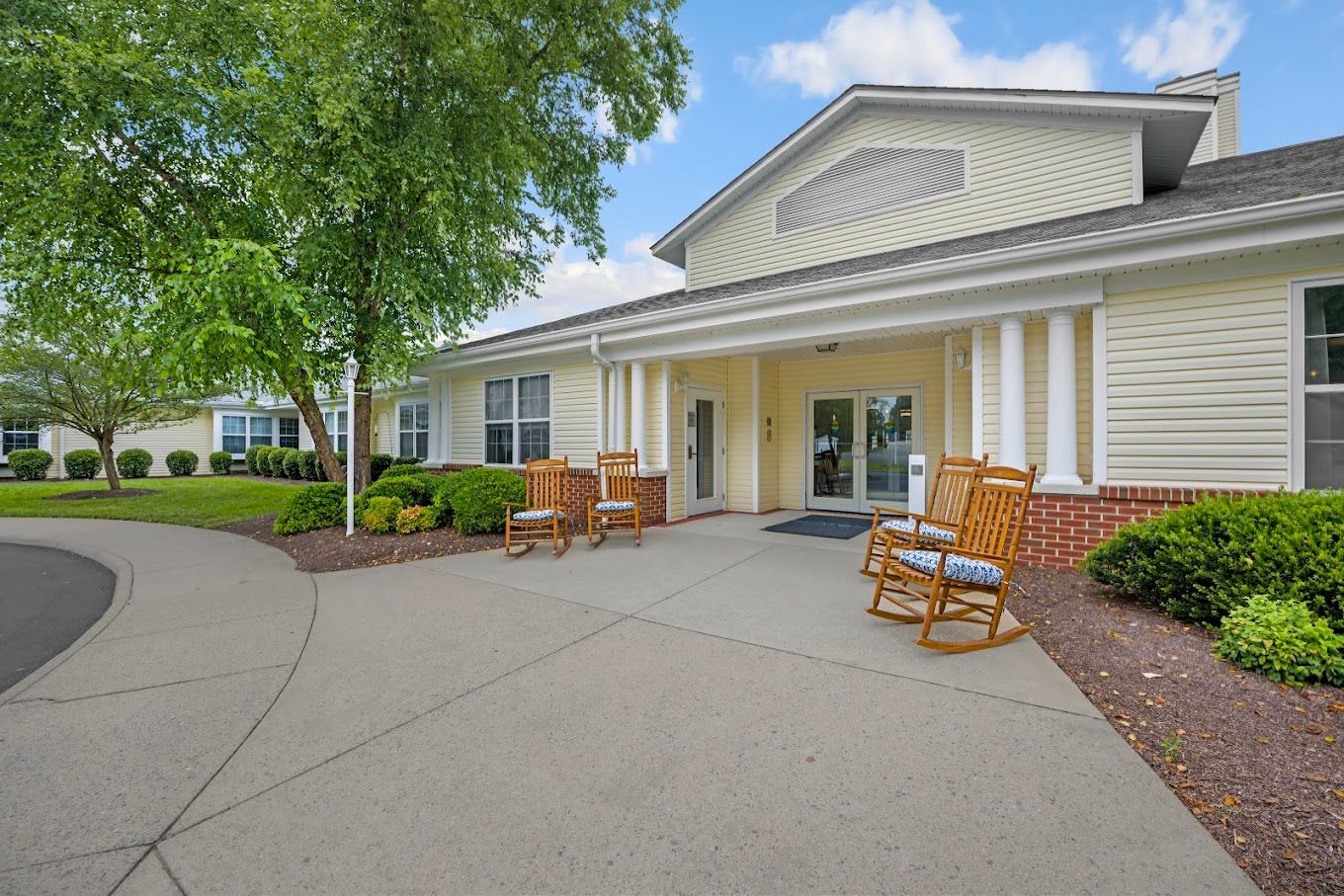 Entrance of a senior living facility with rocking chairs