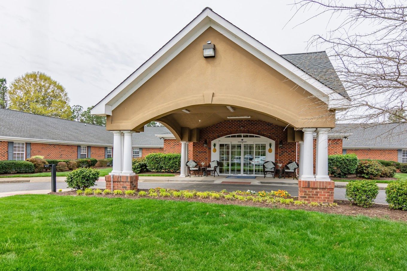 Front entrance of a senior living facility with landscaped area