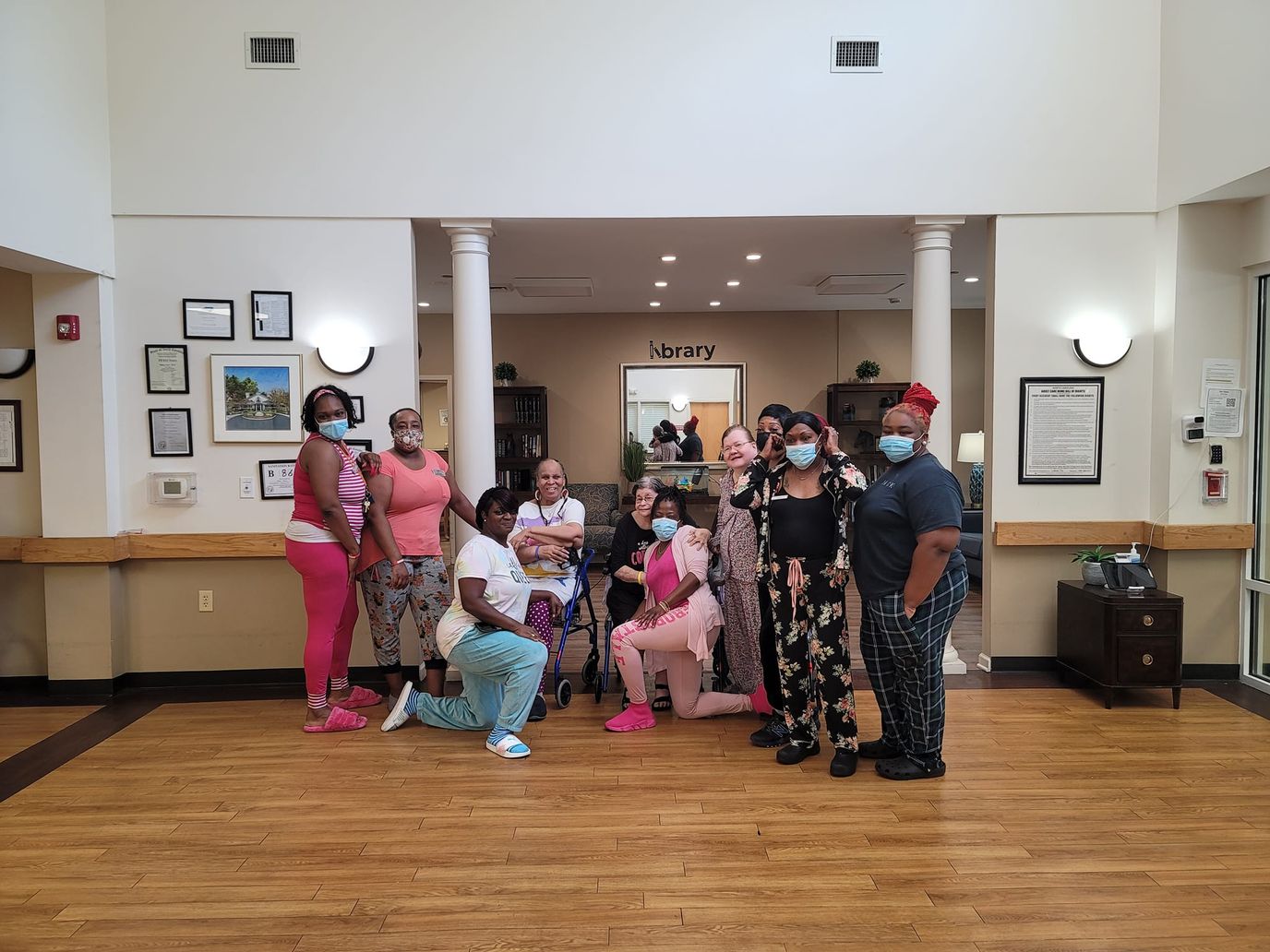 Staff and residents posing in the common area of the facility