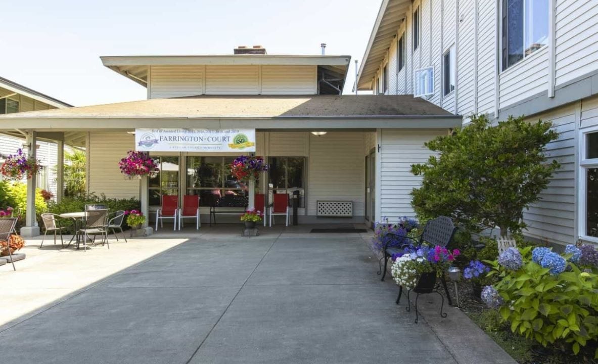 Exterior view of Farrington Court with patio and flowers