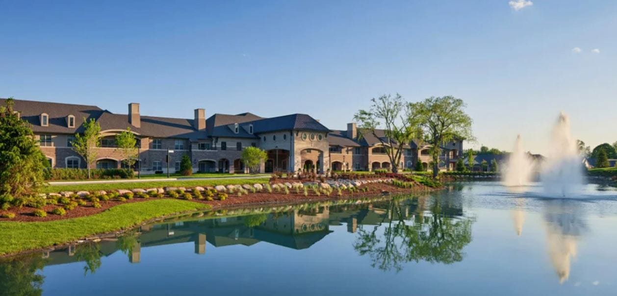 Exterior view of the facility by a tranquil pond
