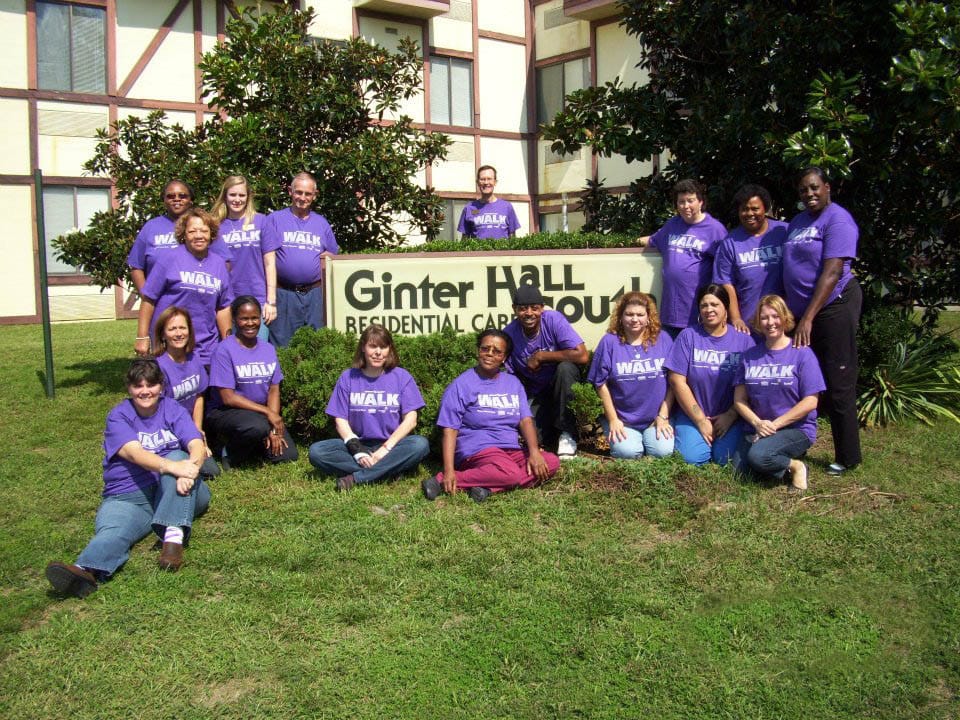 Staff group photo outside Ginter Hall Residential Care