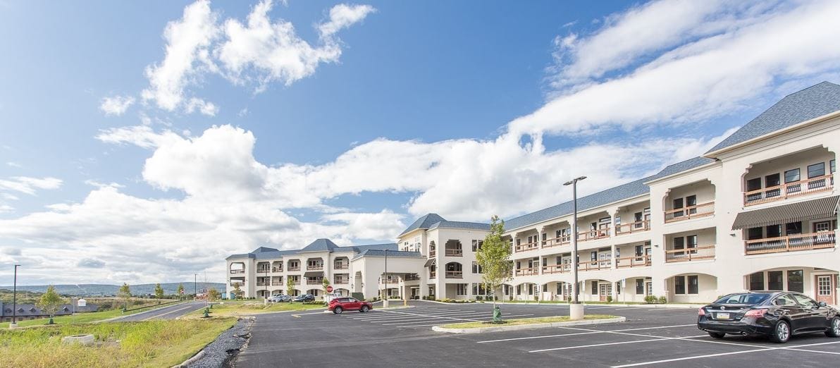 Exterior view of Glenmaura Senior Living facility with parking lot