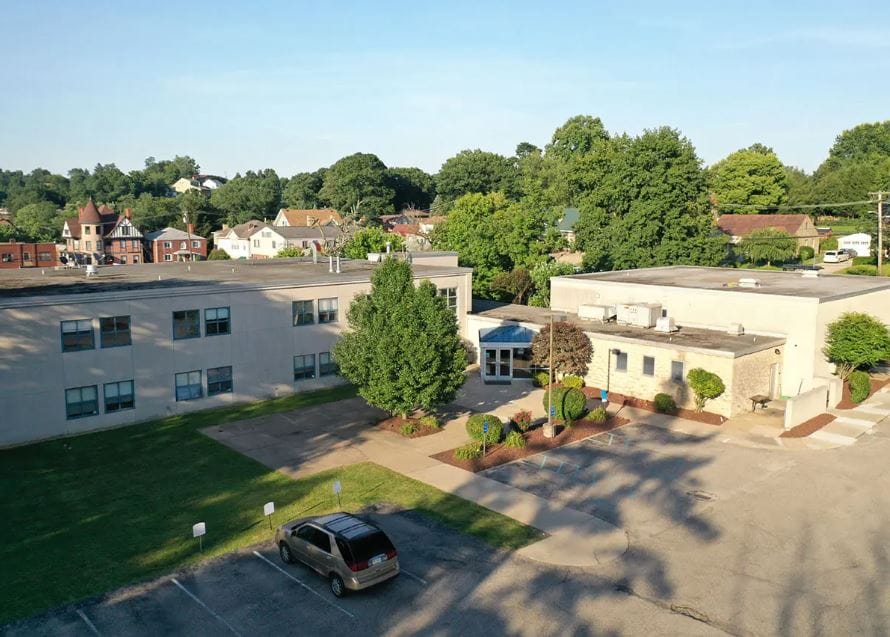 Aerial view of a nursing home facility with landscaped grounds