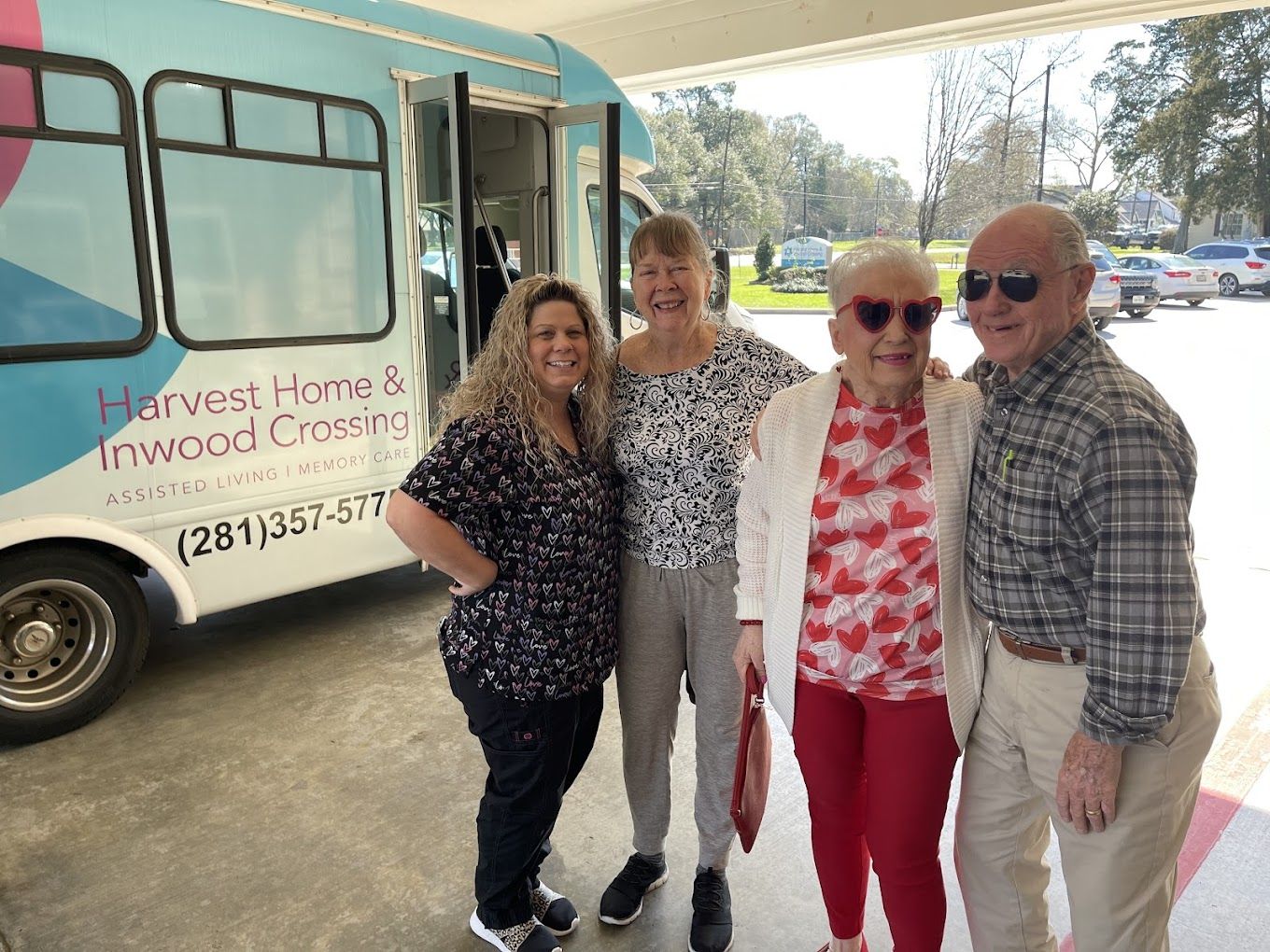 Residents and staff by the facility's transportation van